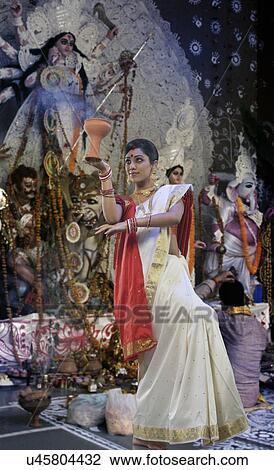 Bengali woman doing a Dhunuchi dance View Large Photo Image Stock Image - Bengali woman doing a Dhunuchi dance . Fotosearch