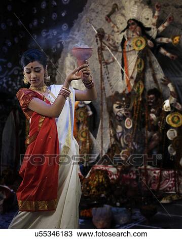 Bengali woman doing a Dhunuchi dance View Large Photo Image Stock Image - Bengali woman doing a Dhunuchi dance . Fotosearch