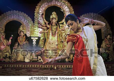 Bengali woman doing a Dhunuchi dance View Large Photo Image Stock Photo - Bengali woman doing a Dhunuchi dance . Fotosearch