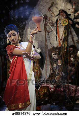 Bengali woman doing a Dhunuchi dance View Large Photo Image Stock Photograph - Bengali woman doing a Dhunuchi dance . Fotosearch