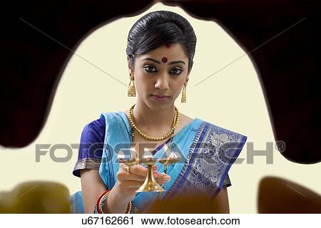 Bengali woman doing a puja View Large Photo Image Stock Image - Bengali woman doing a puja . Fotosearch