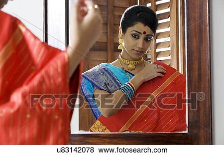 Bengali woman looking at a saree View Large Photo Image Stock Photo - Bengali woman looking at a saree . Fotosearch