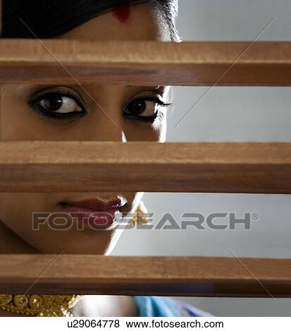 Bengali woman looking through a window View Large Photo Image Stock Photo - Bengali woman looking through a window . Fotosearch