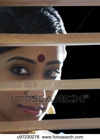 Bengali woman looking through a window View Large Photo Image Stock Photo - Bengali woman looking through a window . Fotosearch