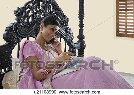 Stock Image - Bengali woman talking on a mobile phone . Fotosearch