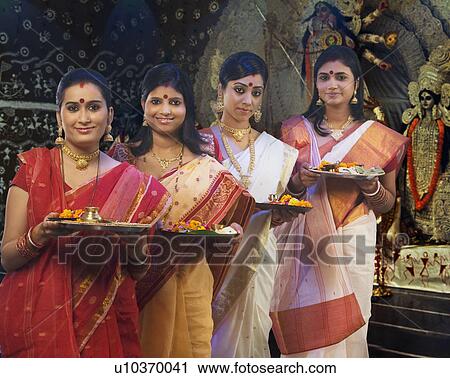 Stock Image - Bengali women celebrating Durga puja . Fotosearch