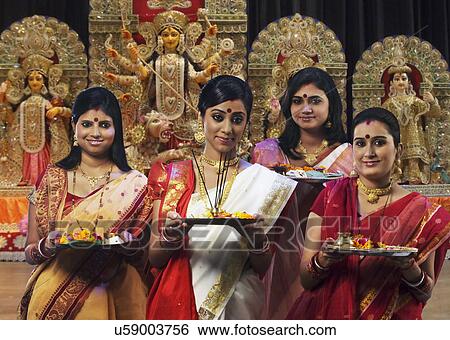 Stock Photograph - Bengali women celebrating Durga puja . Fotosearch