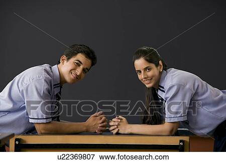 Stock Photo - Boy and girl in front of a blackboard . Fotosearch