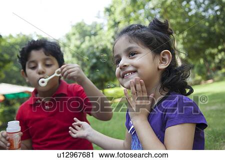 Boy and girl in park View Large Photo Image Stock Image - Boy and girl in park. Fotosearch