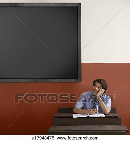 Boy daydreaming in a classroom View Large Photo Image Stock Photograph - Boy daydreaming in a classroom . Fotosearch