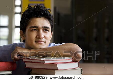 Stock Photo - Boy in a school library . Fotosearch