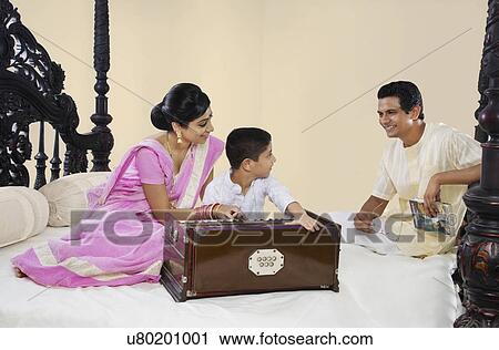 Boy playing on a harmonium View Large Photo Image Stock Image - Boy playing on a harmonium . Fotosearch