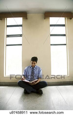 Boy reading in a classroom View Large Photo Image Stock Image - Boy reading in a classroom . Fotosearch