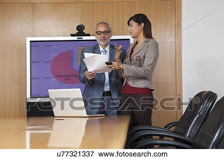 Business executives having a discussion in a conference room View Large Photo Image Stock Photo - Business executives having a discussion in a conference room. Fotosearch