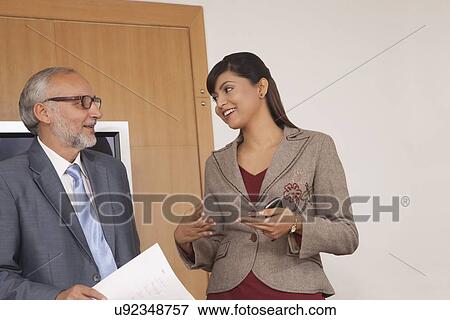 Business executives having a discussion in a conference room View Large Photo Image Stock Photo - Business executives having a discussion in a conference room. Fotosearch