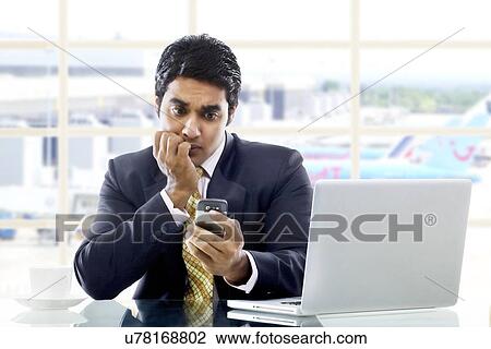 Businessman getting worried after reading an sms View Large Photo Image Stock Image - Businessman getting worried after reading an sms . Fotosearch
