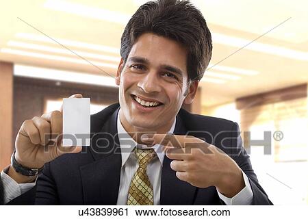 Businessman holding a business card View Large Photo Image Stock Image - Businessman holding a business card . Fotosearch