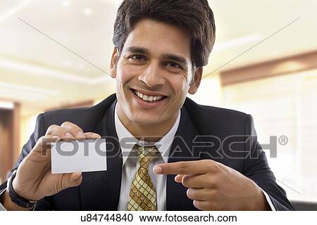 Businessman holding a business card View Large Photo Image Stock Image - Businessman holding a business card . Fotosearch