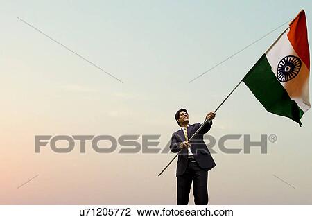 Businessman holding the Indian flag View Large Photo Image Stock Image - Businessman holding the Indian flag . Fotosearch