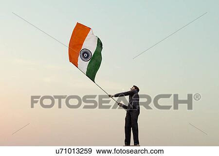 Businessman holding the Indian flag View Large Photo Image Stock Photo - Businessman holding the Indian flag . Fotosearch