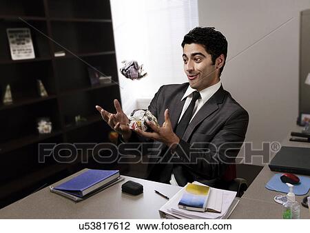 Businessman juggling paper in the office View Large Photo Image Stock Image - Businessman juggling paper in the office . Fotosearch