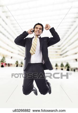 Stock Image - Businessman jumping in the air . Fotosearch