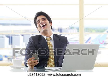 Businessman laughing after reading an sms View Large Photo Image Stock Image - Businessman laughing after reading an sms . Fotosearch