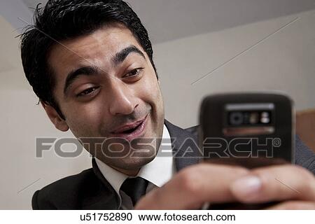 Stock Image - Businessman reading an sms . Fotosearch