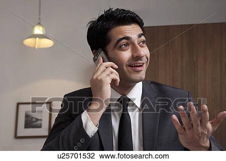 Businessman talking on a mobile phone View Large Photo Image Stock Image - Businessman talking on a mobile phone . Fotosearch