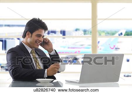 Businessman talking on a mobile phone View Large Photo Image Stock Image - Businessman talking on a mobile phone . Fotosearch