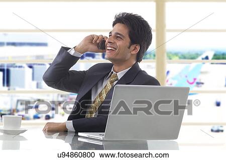 Businessman talking on a mobile phone View Large Photo Image Stock Image - Businessman talking on a mobile phone . Fotosearch