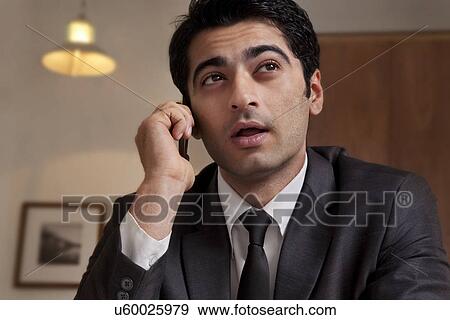 Businessman talking on a mobile phone View Large Photo Image Stock Photo - Businessman talking on a mobile phone . Fotosearch