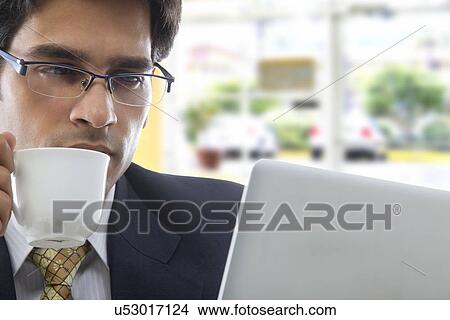 Businessman with a cup of coffee View Large Photo Image Picture - Businessman with a cup of coffee . Fotosearch