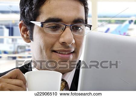 Stock Image - Businessman with a cup of coffee . Fotosearch