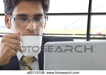 Stock Photo - Businessman with a cup of coffee . Fotosearch