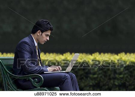 Businessman working on a laptop View Large Photo Image Stock Photography - Businessman working on a laptop . Fotosearch