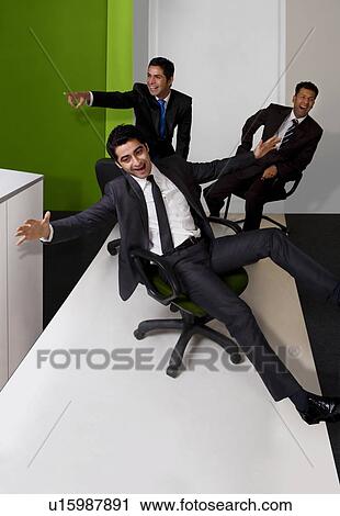 Businessmen having fun in the office View Large Photo Image Stock Image - Businessmen having fun in the office . Fotosearch