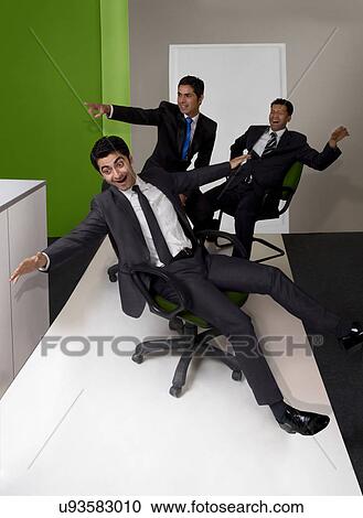 Businessmen having fun in the office View Large Photo Image Stock Image - Businessmen having fun in the office . Fotosearch