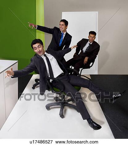 Stock Photo - Businessmen having fun in the office . Fotosearch