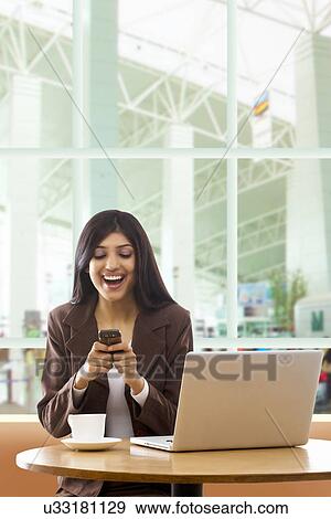 Businesswoman reading an sms on a mobile phone View Large Photo Image Stock Photo - Businesswoman reading an sms on a mobile phone . Fotosearch