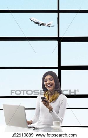 Businesswoman reading an sms on a mobile phone View Large Photo Image Stock Photo - Businesswoman reading an sms on a mobile phone . Fotosearch