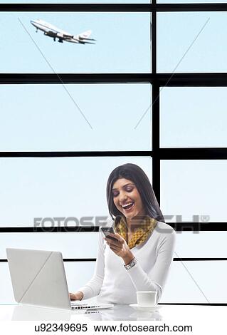 Businesswoman reading an sms on a mobile phone View Large Photo Image Stock Photography - Businesswoman reading an sms on a mobile phone . Fotosearch