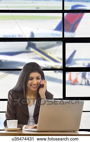 Stock Image - Businesswoman talking on a mobile phone . Fotosearch