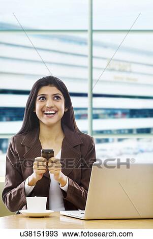 Stock Image - Businesswoman with a mobile phone . Fotosearch