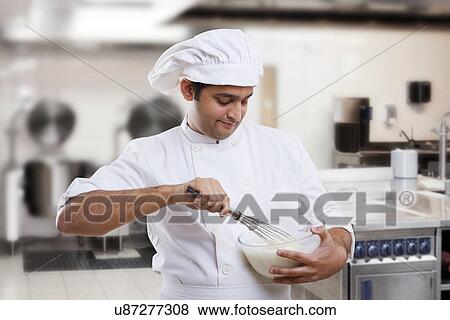 Chef beating dough in a bowl  View Large Photo Image Stock Photo - Chef beating dough in a bowl . Fotosearch