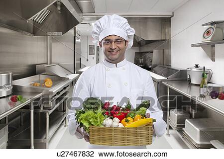 Chef carrying a basket of fresh vegetables View Large Photo Image Stock Image - Chef carrying a basket of fresh vegetables . Fotosearch