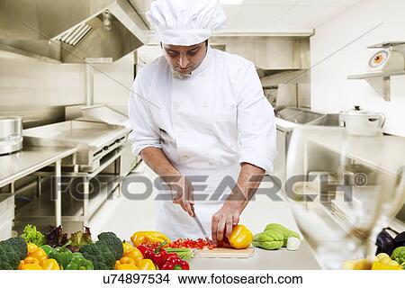 Picture - Chef cutting vegetables in the kitchen . Fotosearch