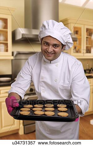 Stock Photo - Chef offering baked cookies . Fotosearch