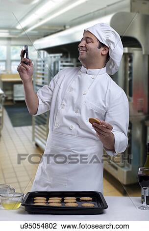 Chef reading an sms View Large Photo Image Stock Image - Chef reading an sms . Fotosearch