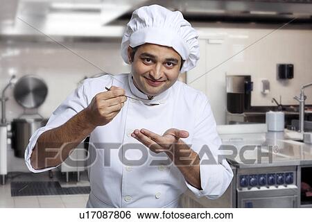 Chef tasting his cooking View Large Photo Image Stock Photograph - Chef tasting his cooking . Fotosearch